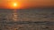 Picturesque huge round red sunset or dawn at sea sun over water surface. Reflected in sea sun ray and sunrise over the