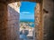 Picturesque Hvar Island, viewed through a doorway in its medieval fortress.