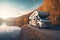 A picturesque image of a unrecognizable motorhome parked by a serene lakeside, showcasing the freedom and tranquility of a