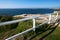 Picturesque and impressive oceanside landscape with grass and white wood guardrail on cliff by sea in Sydney, Australia