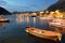 Picturesque Kotor bay at blue hour. Wonderful boats on te seascape backgrond of coast of Adriatic sea