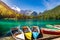 Picturesque lake Lago Fusine with colorful boats. Fusine lake with Mangart peak on background. Popular travel destination of