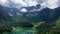 Picturesque lake Lago Fusine in Italy. Fusine lake with Mangart peak on background. Popular travel destination of Julian Alps.