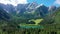 Picturesque lake Lago Fusine in Italy. Fusine lake with Mangart peak on background. Popular travel destination of Julian Alps.