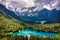 Picturesque lake Lago Fusine in Italy. Fusine lake with Mangart peak on background. Popular travel destination of Julian Alps.