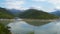 A picturesque lake among the mountains covered by forest.