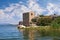 Picturesque lake with ruined fort on small island. National Park Lake Skadar and Fortress Grmozur on summer day. Montenegro