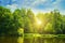 Picturesque lake, summer forest on banks and the sunrise