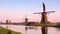 The picturesque landscape with aerial mills on the channel in Kinderdiyk, Netherlands at sunset. Full HD video.