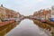 Picturesque landscape with beautiful traditional houses reflection in canal, Haarlem, Holland
