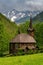 Picturesque landscape with church and high gables, meadow and green trees. Wooden church, Tatranska Javorina, High Tatra Mountains