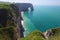 Picturesque landscape on the cliff of Etretat. la Manneporte natural rock arch wonder, cliff and beach