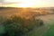 Picturesque landscape featuring a sprawling field at sunset