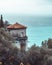 Picturesque landscape of an old castle atop a hill overlooking a tranquil shoreline in France