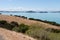 Picturesque landscape with slope, blue sea and mountains on background in a sunny day, Duder Regional Park, Auckland city, New