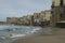 Picturesque landscape view of coastline in ancient city Cefalu. Colorful buildings at the sandy beach