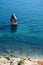 A picturesque lonely large stone stands on all sides surrounded by water