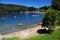 picturesque manzano bay, with luxurious hotels and apartments with docks and boats on lake nahuel huapi