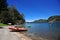 picturesque manzano bay, with luxurious hotels and apartments with docks and boats on lake nahuel huapi and mountains with blue sk