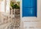 Picturesque mediterranean street with white walls and a blue door