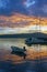 Picturesque Mediterranean sunset with silhouettes of boats on water. Montenegro, Bay of Kotor