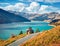 Picturesque morning view of Roselend lake/Lac de Roselend. Sunny autumn scene of Auvergne-Rhone-Alpes, France, Europe. Beauty of n