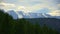 Picturesque mountain ranges covered with snow and glade with pine trees in the foreground. Altai. Siberia. Russia