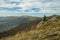 Picturesque mountain ridge wilderness highland environment with lonely tree on top and cloudy moody weather time of autumn season