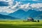 Picturesque mountain valley landscape with lush green rice fields against a cloudy sky