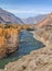 Picturesque mountain valley, wild river, forest on the shore