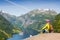 Picturesque Norway mountain landscape. Young girl enjoying the view near Geiranger fjord, Norway