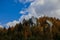 Picturesque October fall season dramatic landscape scenic view of rocks in brown foliage environment space and cloudy moody