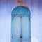 Picturesque old arctic blue wood door and cerulean blue wall