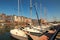 Picturesque old harbour at the Normandy village of Honfleur France with boats, yachts, cafes and the sea on a sunny spring day