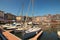 Picturesque old harbour at the Normandy village of Honfleur France with boats, yachts, cafes and the sea on a sunny spring day.