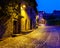 Picturesque old stone town street with street lamps at dusk. Santillana