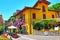 Picturesque outdoor Italian restaurant seating street view from Gardone Riviera town Italy