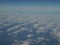 Picturesque panorama of blue sky and cloud as seen through window of an aircraft above Europe