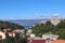 Picturesque panorama of the city of Vrbnik with ancient buildings and a tower on a high slope above the blue sea, Krk island, Croa