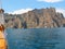 A picturesque panorama of the impregnable cliffs of the extinct volcano Karadag from the side of a pleasure yacht against a bright