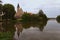 A picturesque park with a lake near the castle of Telc. Ancient buildings at the background. Summer landscape photo