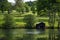 Picturesque pastures with sheep and lake with old boat house, Scotland, UK