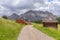 A picturesque path through an alpine meadow in the Italian Dolomites for hiking and cycling.