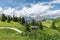 A picturesque path through an alpine meadow in the Italian Dolomites for hiking and cycling. Italian Alps