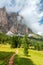 Picturesque path on a high alpine meadow with misty peaks of Italian Dolomites.