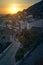 Picturesque picture of a sunset over a village with a stone path leading to the bougainvillea