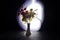 Picturesque purple spring flowers in glass vase standing in a row on a dark background with stars with light and fog. Close up