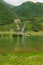 Picturesque quiet lake and stream on green hills