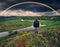 picturesque rainbow over the river. tourist enjoys colorful sunrise