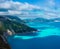 Picturesque rocky coastline on Kefalonia island. Amazing landscape with cloudscape and shadows on sea surface. Greece